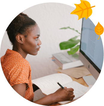 Person with notebook, computer, and leaves